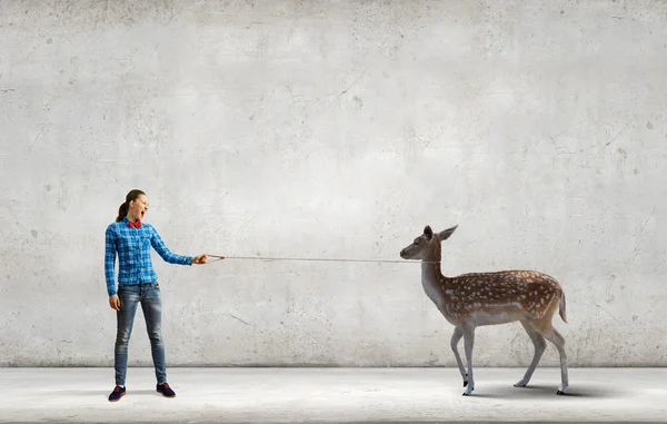 Woman holding fawn on lead — Stock Photo, Image