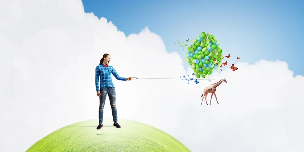 Woman and giraffe flying in sky — Stock Photo, Image