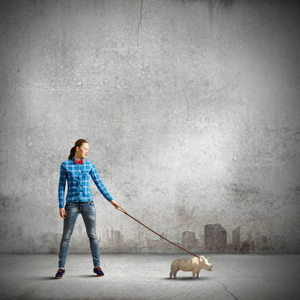 Woman holding rhino on lead — Stock Photo, Image