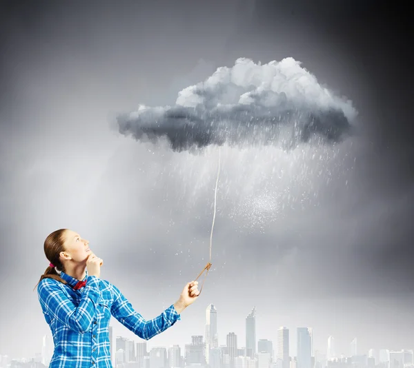 Woman holding cloud on lead — Stock Photo, Image