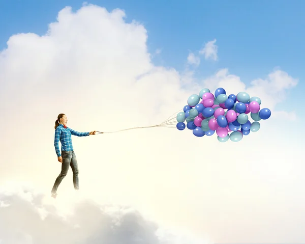 Woman holding colorful balloons — Stock Photo, Image