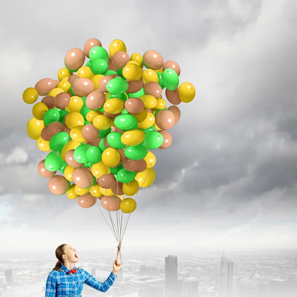 Woman holding colorful balloons — Stock Photo, Image