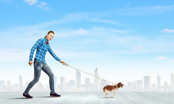 Woman with dog on lead — Stock Photo, Image