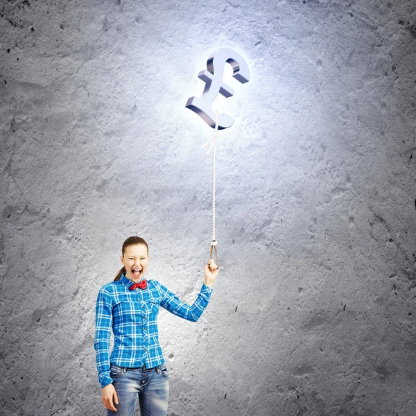 Woman holding pound shaped balloon — Stock Photo, Image