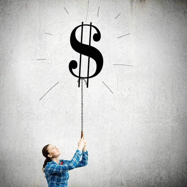 Woman holding dollar shaped balloon — Stock Photo, Image