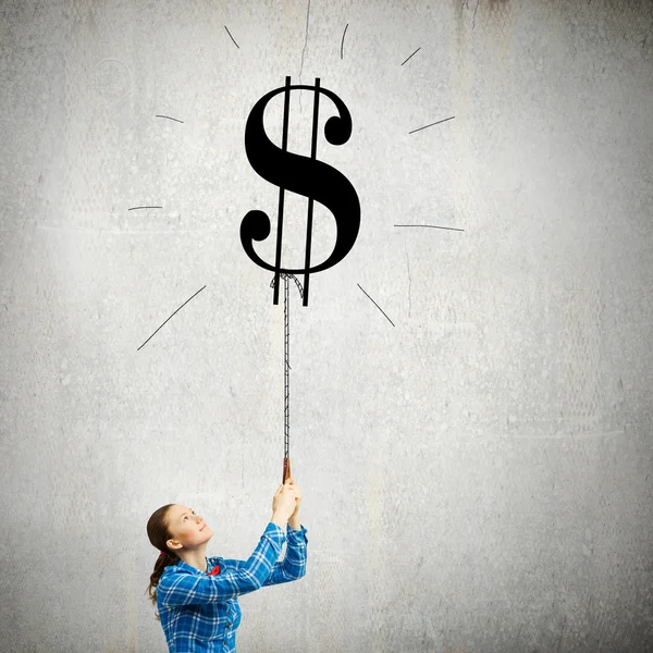 Woman holding dollar shaped balloon — Stock Photo, Image