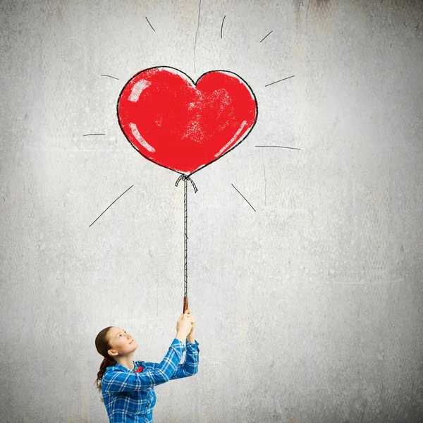Woman holding heart shaped balloon — Stock Photo, Image