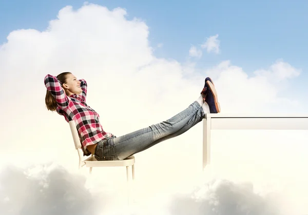 Woman with legs on table — Stock Photo, Image