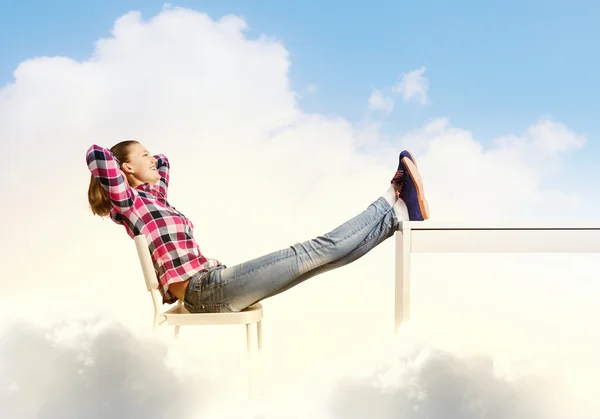 Woman with legs on table — Stock Photo, Image