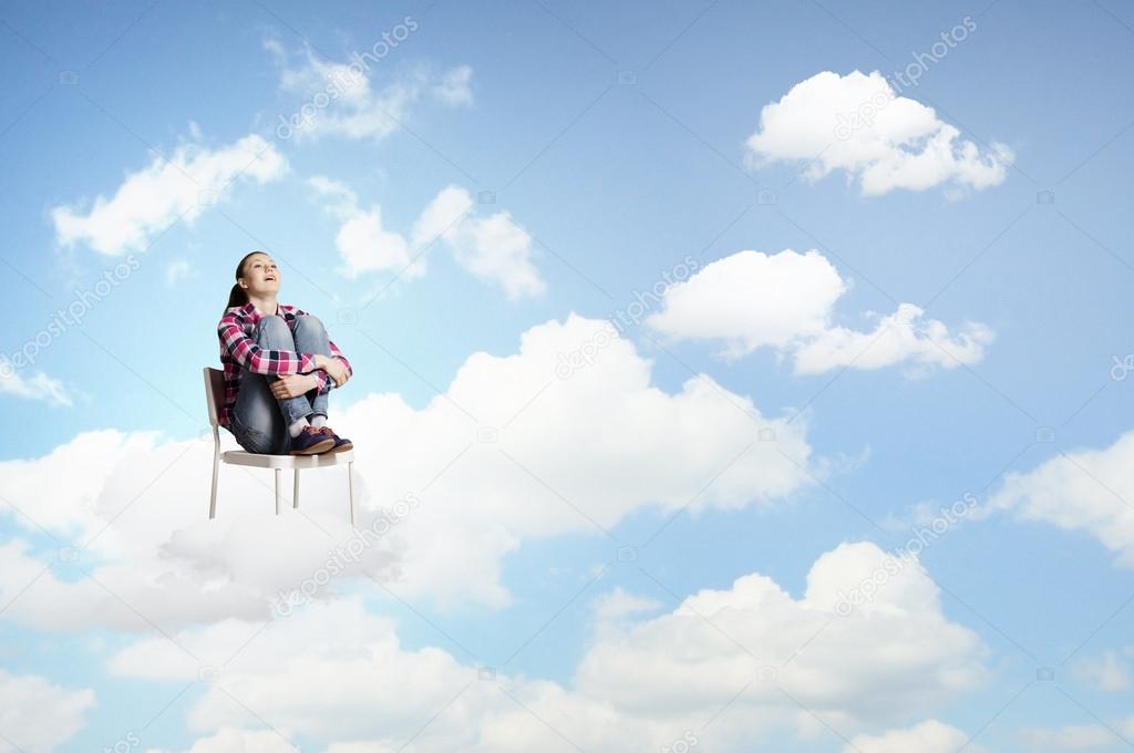 Woman sitting on cloud