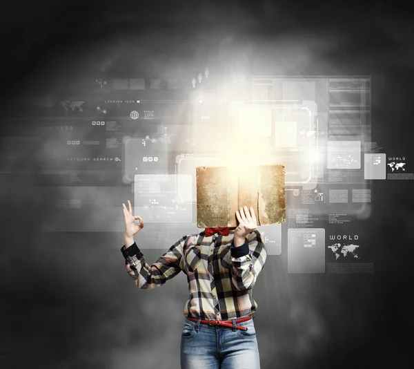 Woman hiding face behind book — Stock Photo, Image