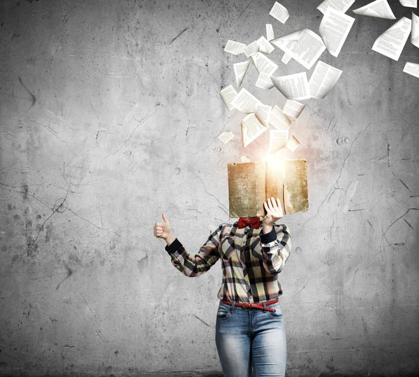 Woman hiding face behind book — Stock Photo, Image