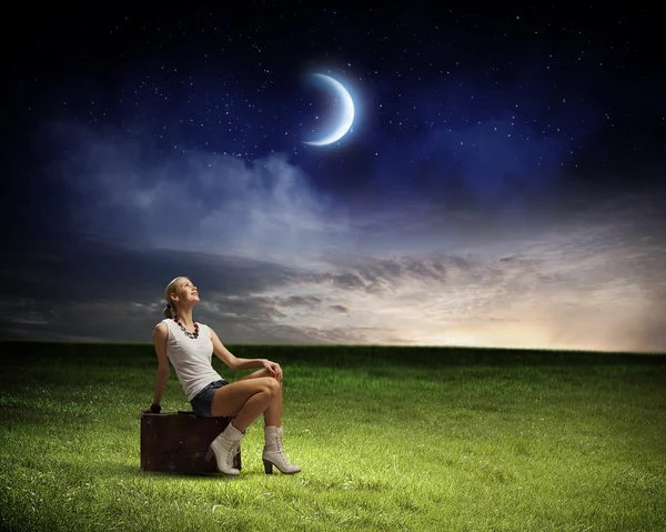 Woman sitting on briefcase — Stock Photo, Image