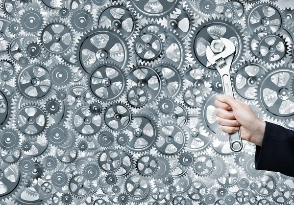 Businessman hand fixing mechanism — Stock Photo, Image