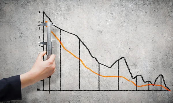 Hand measuring graph with ruler — Stock Photo, Image