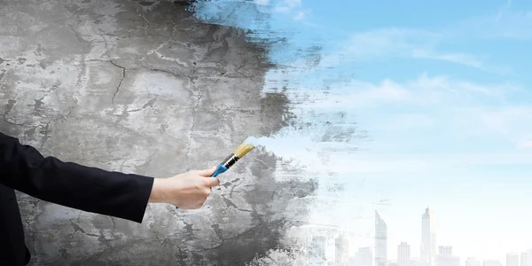 Hand painting wall with brush — Stock Photo, Image