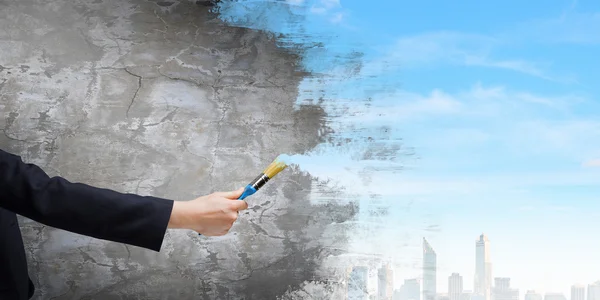 Hand painting wall with brush — Stock Photo, Image