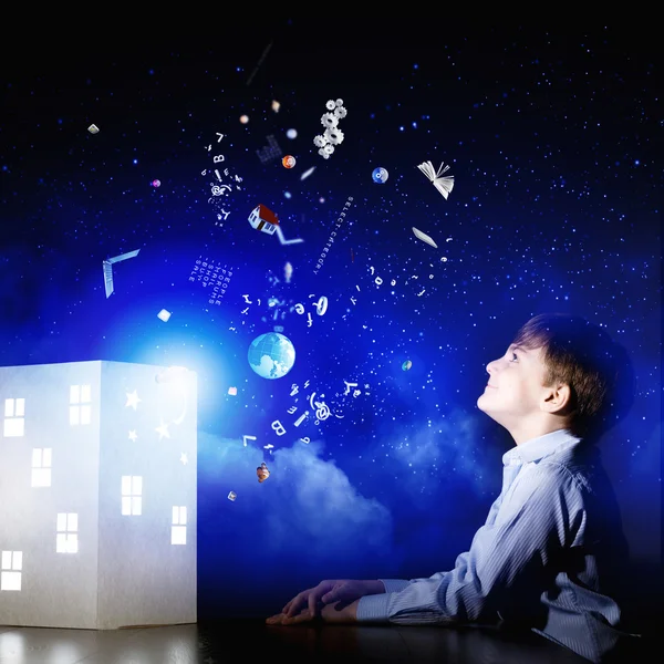 Boy looking at model of house — Stock Photo, Image