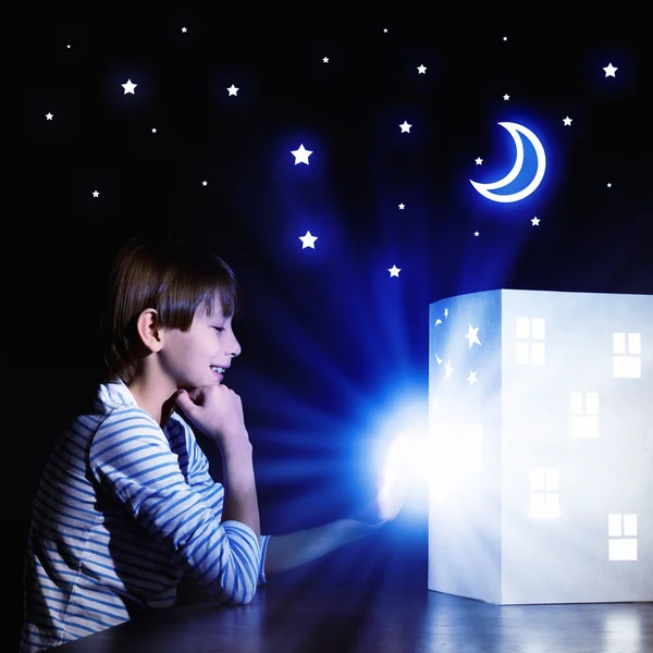 Boy looking at model of house — Stock Photo, Image