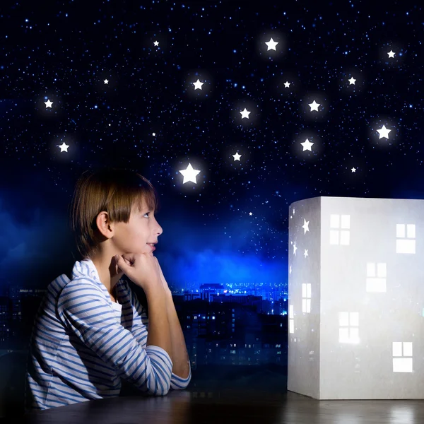 Boy looking at model of house — Stock Photo, Image