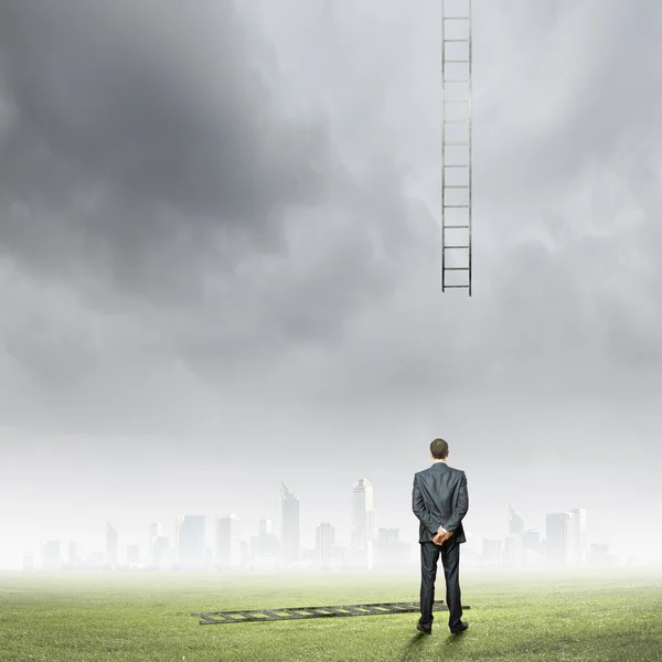 Businessman looking at broken ladder — Stock Photo, Image