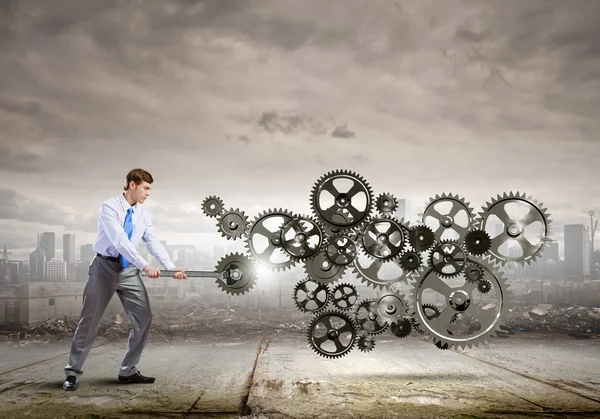 Businessman with wrench fixing mechanism — Stock Photo, Image