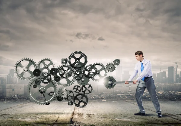 Businessman with wrench fixing mechanism — Stock Photo, Image