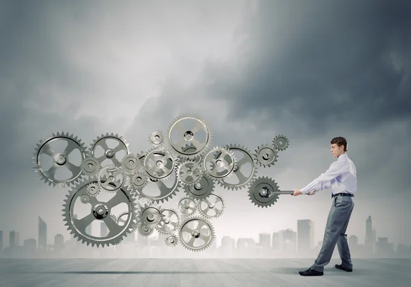 Businessman with wrench fixing mechanism — Stock Photo, Image