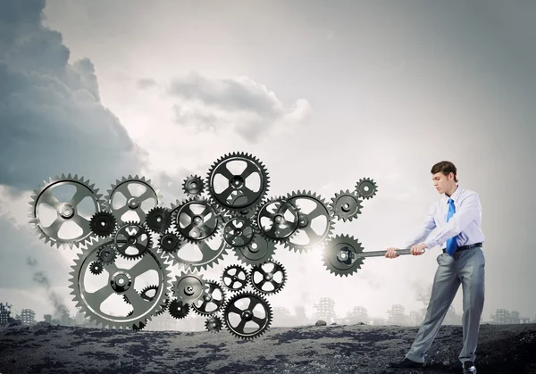 Businessman with wrench fixing mechanism — Stock Photo, Image