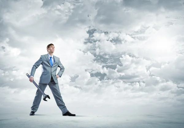 Businessman with wrench — Stock Photo, Image