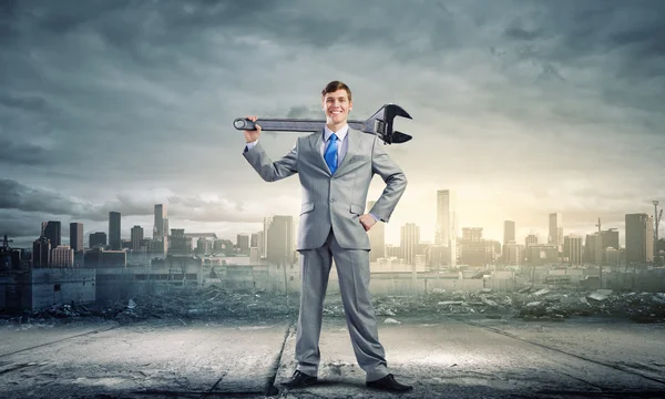 Businessman with wrench — Stock Photo, Image