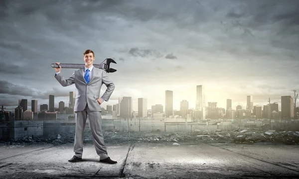 Businessman with wrench — Stock Photo, Image