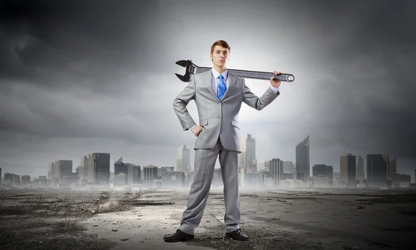 Businessman with wrench — Stock Photo, Image