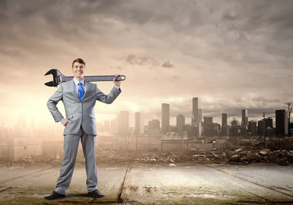 Businessman with wrench — Stock Photo, Image