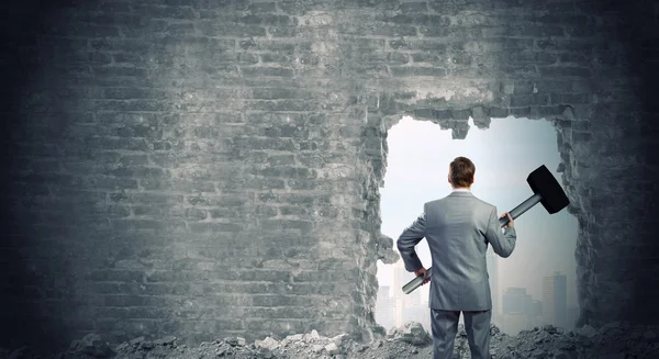 Businessman with big hammer in hands — Stock Photo, Image