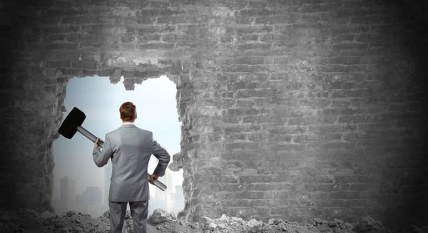 Businessman with big hammer in hands — Stock Photo, Image