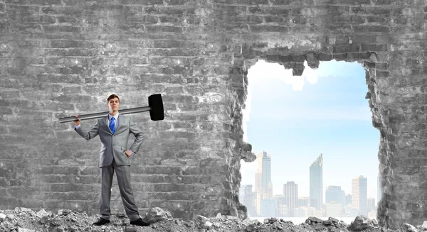 Businessman with big hammer in hands — Stock Photo, Image