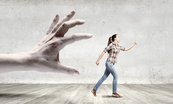 Woman escaping from hand — Stock Photo, Image