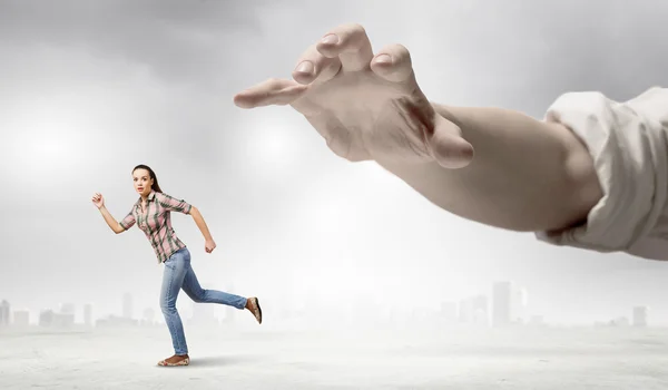 Woman escaping from hand — Stock Photo, Image