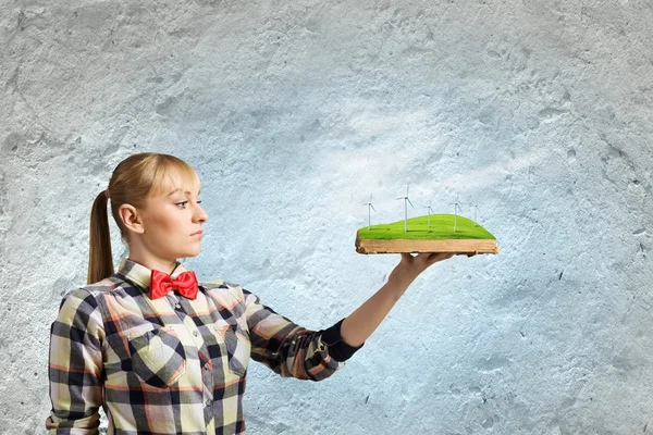 Woman holding book with windmills — Stock Photo, Image