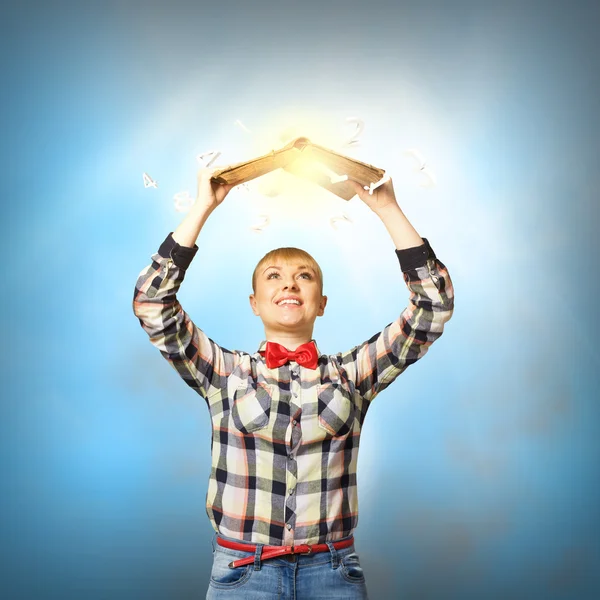 Woman holding book above head — Stock Photo, Image