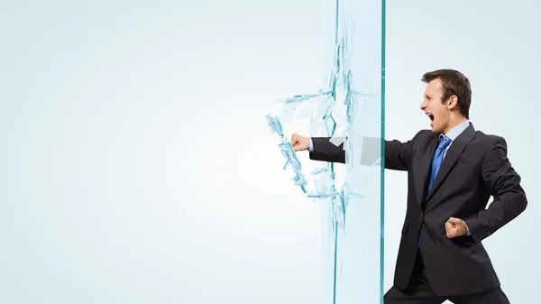 Empresário quebrando vidro — Fotografia de Stock