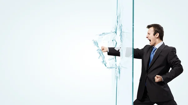 Businessman breaking glass — Stock Photo, Image