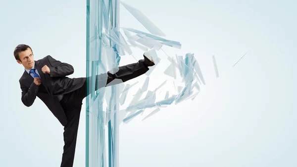 Businessman breaking glass — Stock Photo, Image