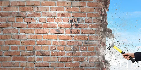 Businessman hand crashing brick wall — Stock Photo, Image