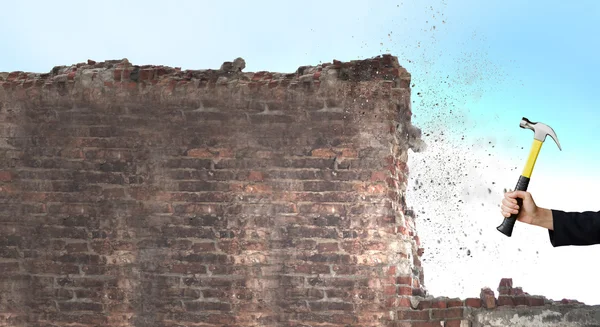 Businessman hand crashing brick wall — Stock Photo, Image