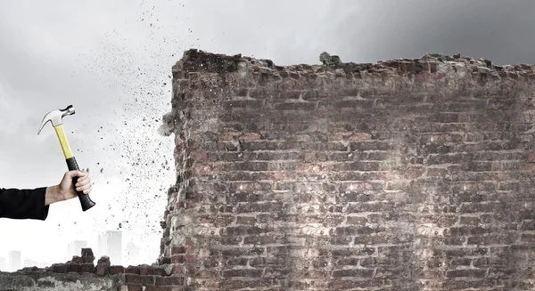 Businessman hand crashing brick wall — Stock Photo, Image