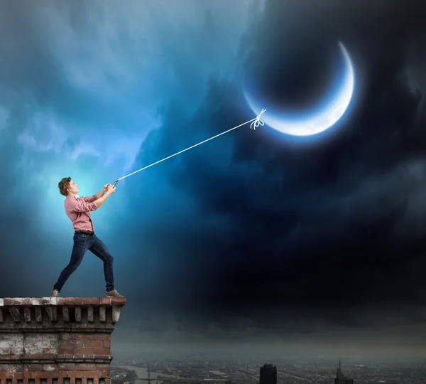 Man catching moon — Stock Photo, Image