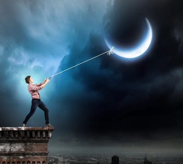 Man catching moon — Stock Photo, Image