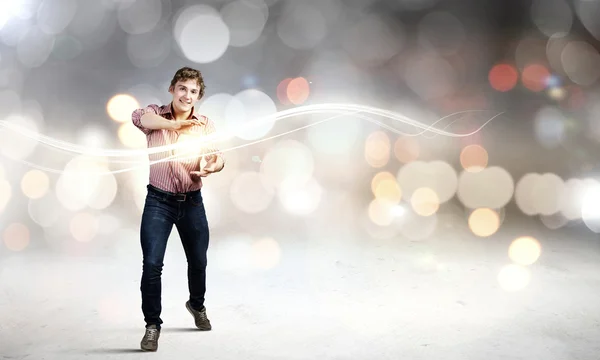 Man throwing light splashes — Stock Photo, Image